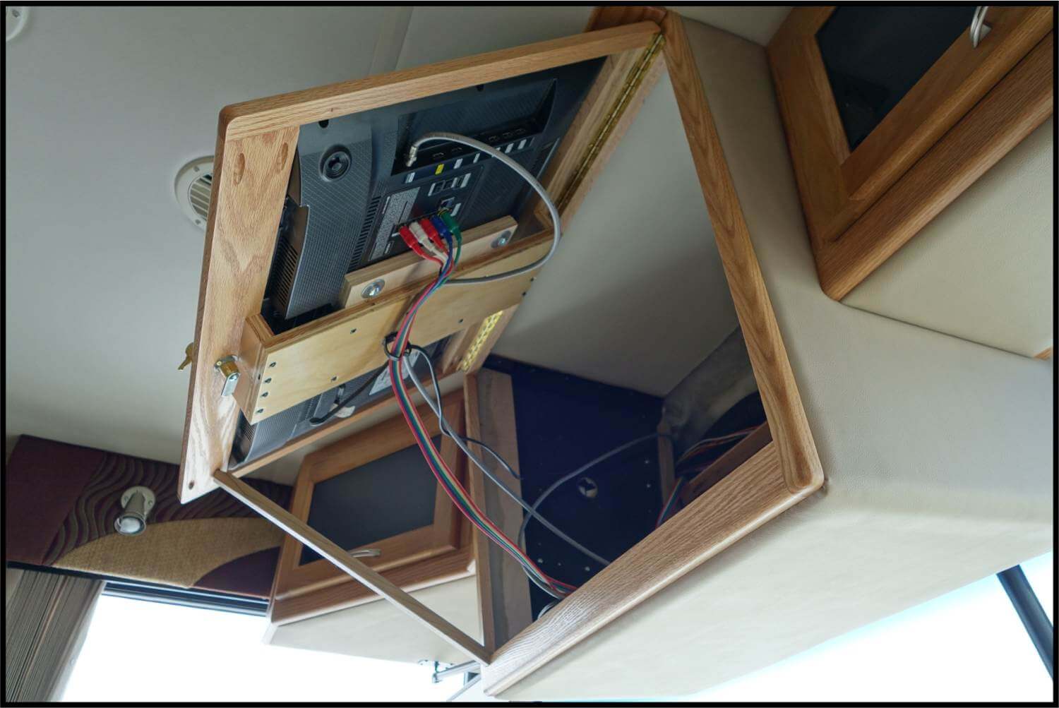front-overhead-tv-rv-cabinet Front overhead TV RV cabinet lifted to show wiring